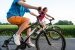 Städtisches Fahrrad fahrendes Mädchen und Junge im Stadtpark