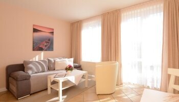 Beispielfoto eines Appartaments mit Wohnzimmer, Schlafzimmer, Küche, Dusche-WC und Balkon oder Terrasse