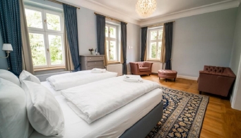 Lichtdurchflutet und weitläufig eröffnet die Blaue Suite den Blick auf den alten Baumbestand des Schlosshotels. Ein separater Ankleidebereich und eine Badewanne zeugen von großzügigen Platzverhältnissen. 