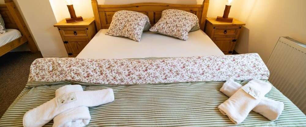 Doppelzimmer mit einem geräumigen Bett, einer voll ausgestatteten Küchenzeile und einem eigenen Eingang vom Innenhof.