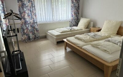 Die Ferienwohnung 4 ist für bis zu 11 Personen geeignet und erstreckt sich über zwei Etagen. Ohne Wohnzimmer.  
Im EG: 1 Zimmer mit 1 Doppelbett + 1 Einzelbett für 3 Personen, 1 Zimmer mit 3 Einzelbetten für 3 Personen, Küche, (ca. 9 m²) Bad, Balkon, Toi