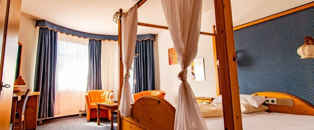 Das Himmelbett-Zimmer entspricht in Stil und Atmosphäre einem Schwarzwald-Zimmer, setzt jedoch mit seinem romantischen Himmelbett einen besonderen Akzent. Mit viel Liebe zum Detail gestaltet, verbindet es traditionellen Schwarzwald-Charme mit modernem Kom